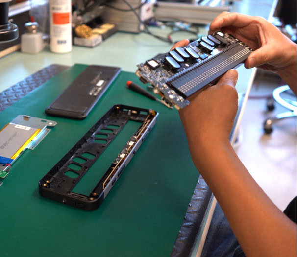 A person checks and assembles the mechanical and electronic components of the Brailliant BI 40X.